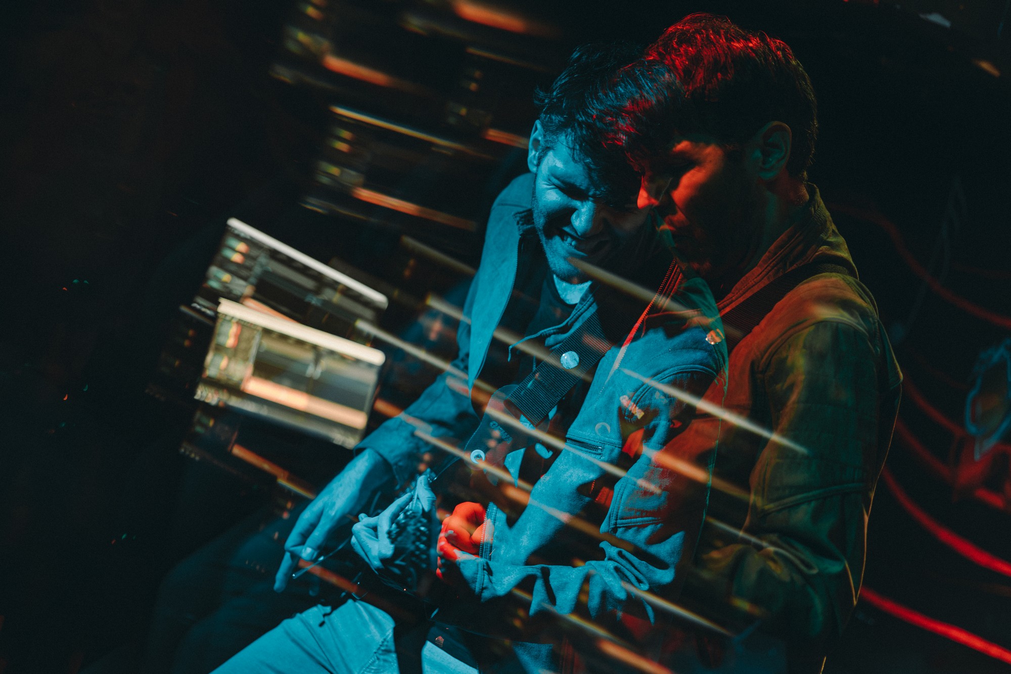 Concert photography - guitarists under orange stage lights