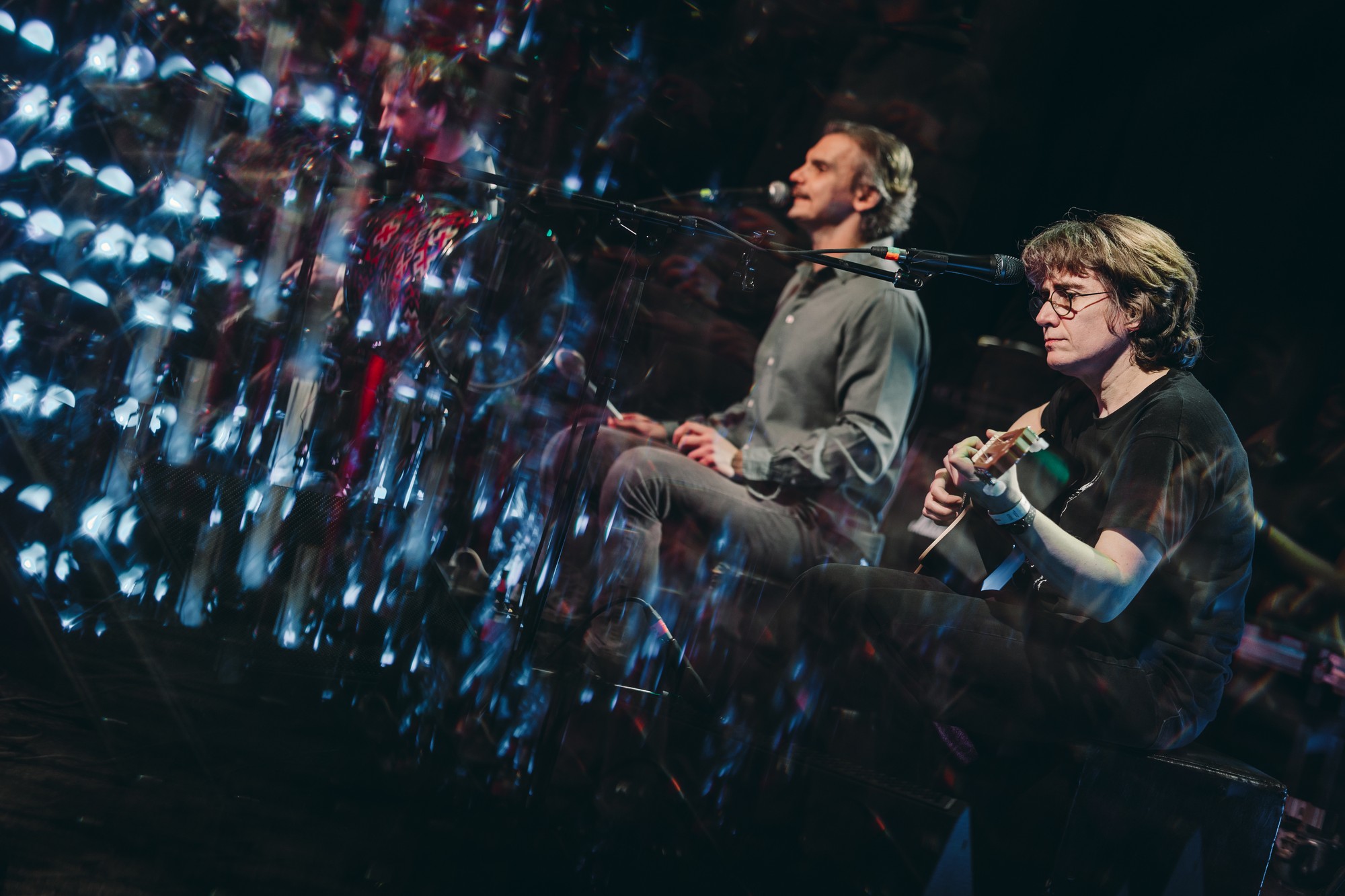 Band reflected on stage with blue lighting